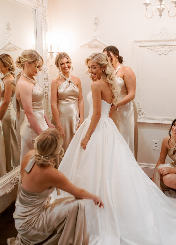 Wedding venue dressing suite with bride wearing a wedding dress and bridesmaid dresses