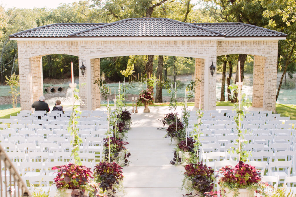 Fort Worth Texas wedding venue luxury ceremony with water views, luxury chairs and elegant wedding flowers