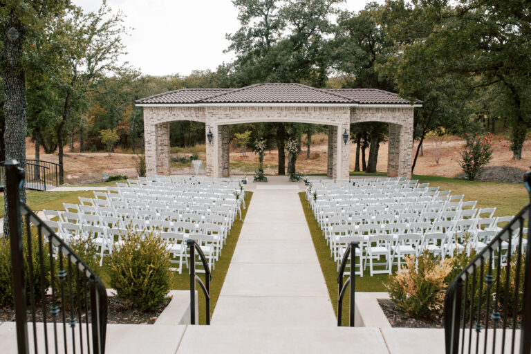 Fort Worth wedding venue ceremony with luxury chairs & elegant wedding flowers and decor