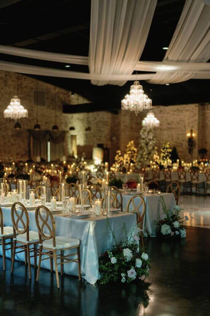 Fort Worth wedding venue reception with luxury tables, upgraded chairs, elegant chandeliers, lighting and decor
