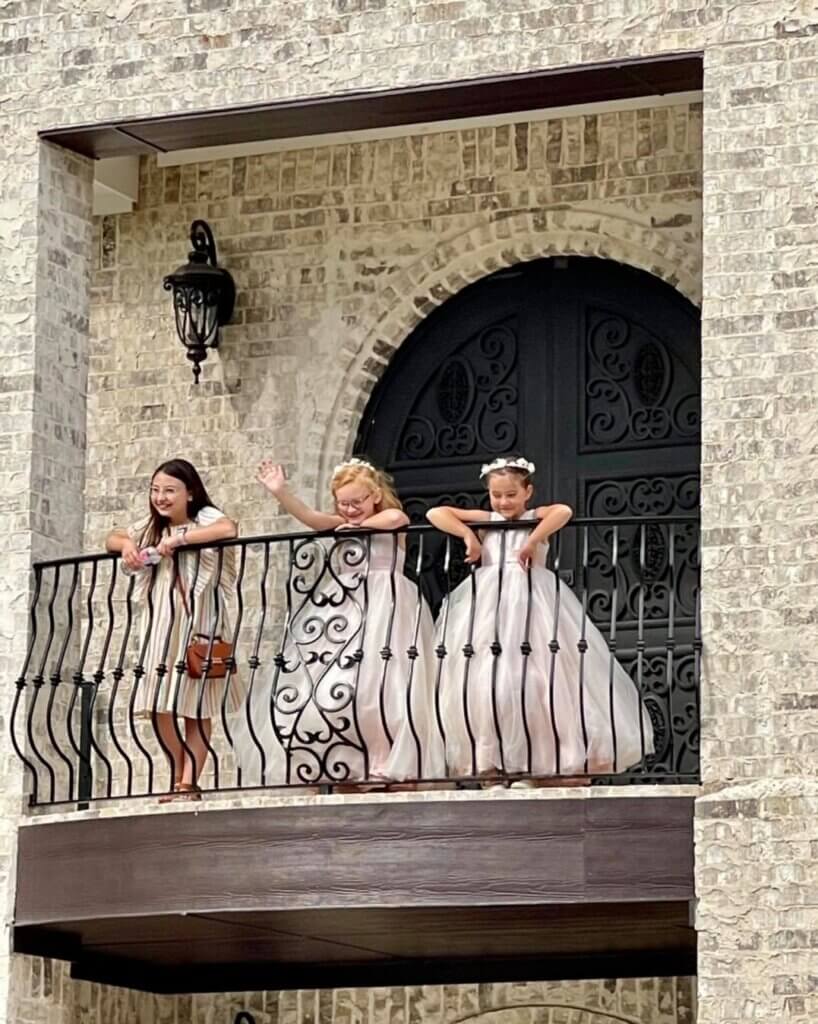 Flower girls wearing elegant white dresses at a luxury wedding venue near Fort Worth