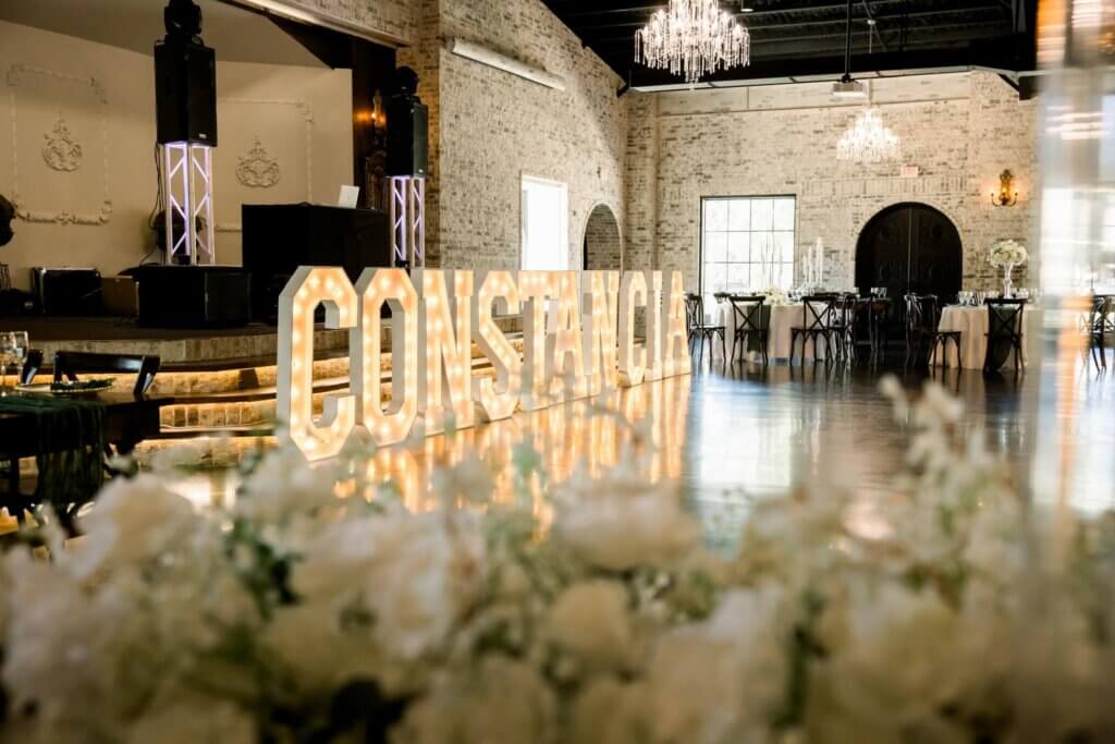 Fort Worth wedding reception with luxury flowers, table settings, chandeliers, elegant features & decor. 